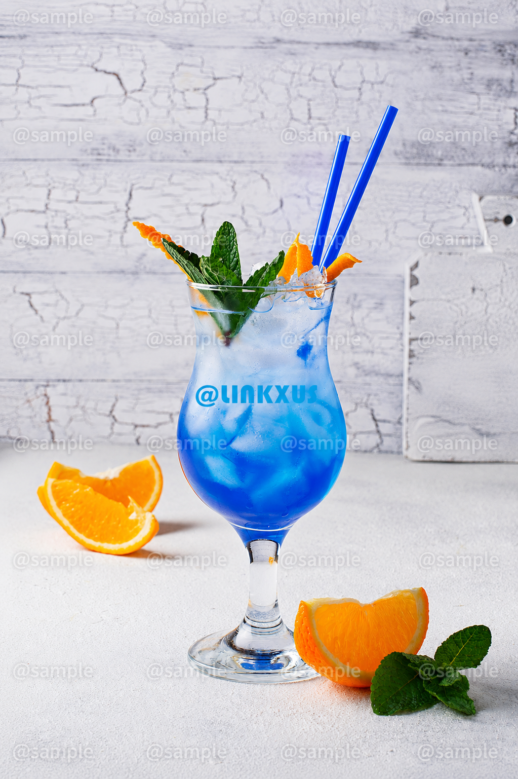 BLUE COCKTAIL DRINK WITH ICE AND ORANGE
