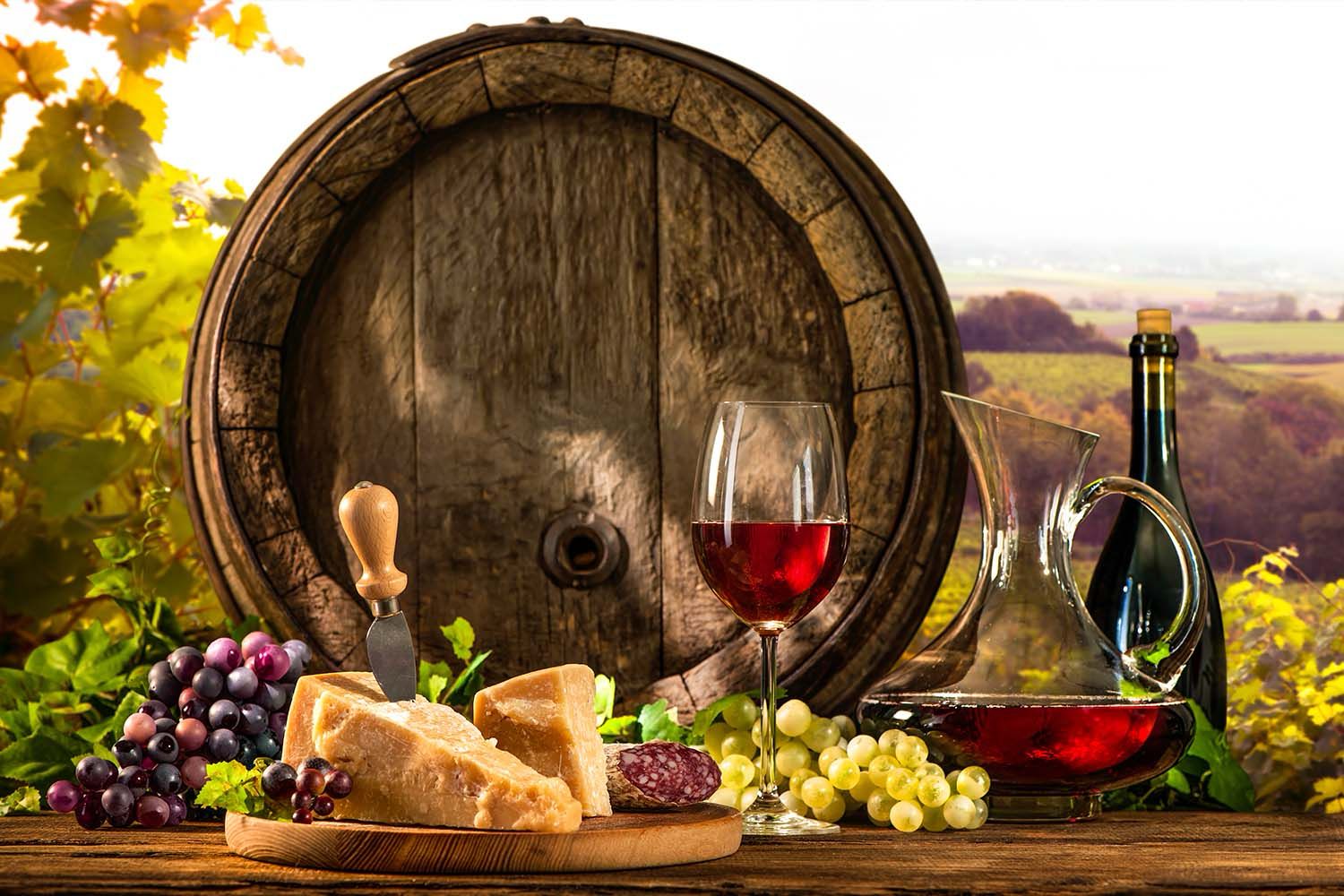 BARREL WITH GLASS OF RED WINE AND CHEESE